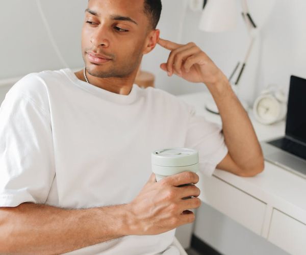 A person sitting at a modern desk incorporating a brief wellness break.